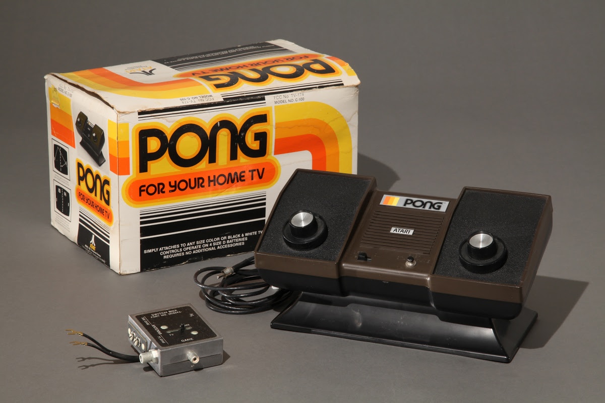 Atari's Home Pong Console sitting next to its colorful packaging.